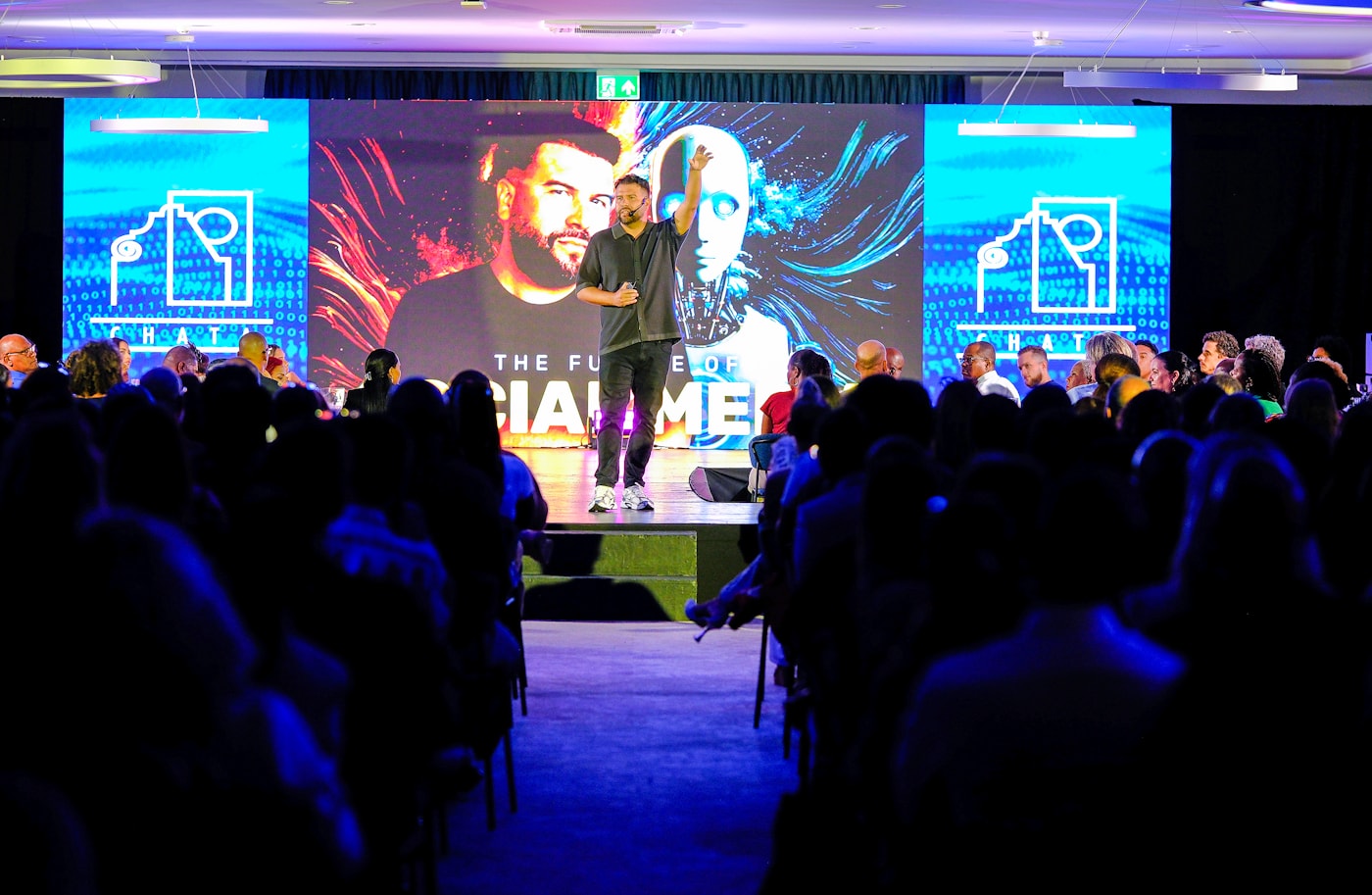 Speaker presenting to a live conference audience